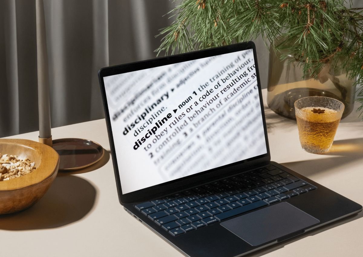 A laptop on a quiet morning desk showing the definition of discipline